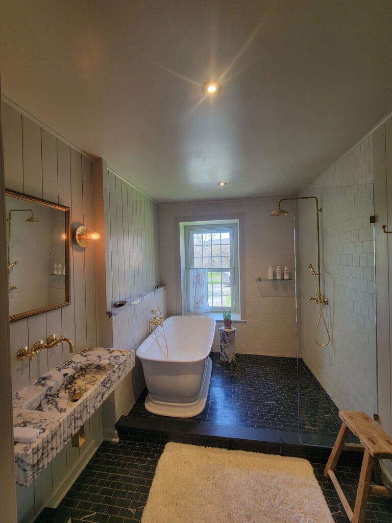 Completed bathroom with freestanding tub and open tile shower