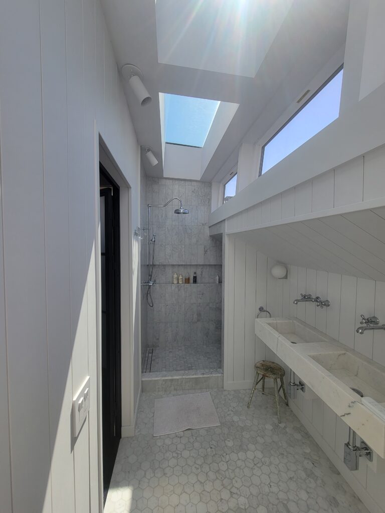 Custom tile walk-in shower and long vanity in a completed bathroom remodel