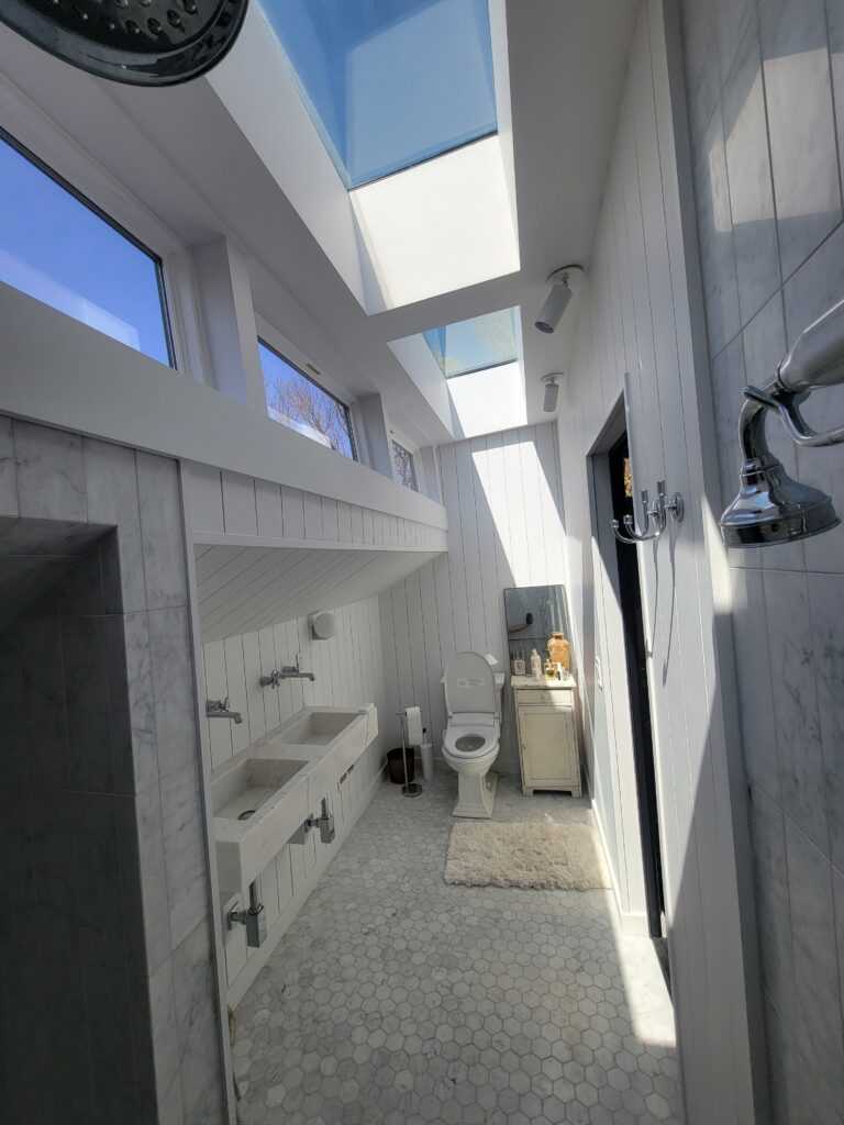 Completed skylit bathroom with custom tile walk-in shower