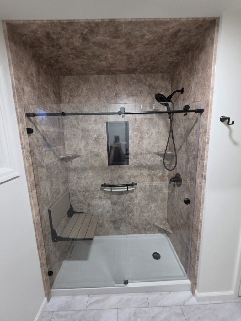 Completed Moore Done Right low-threshold acrylic shower in Selkirk, NY with fold-down seat, handheld shower and glass