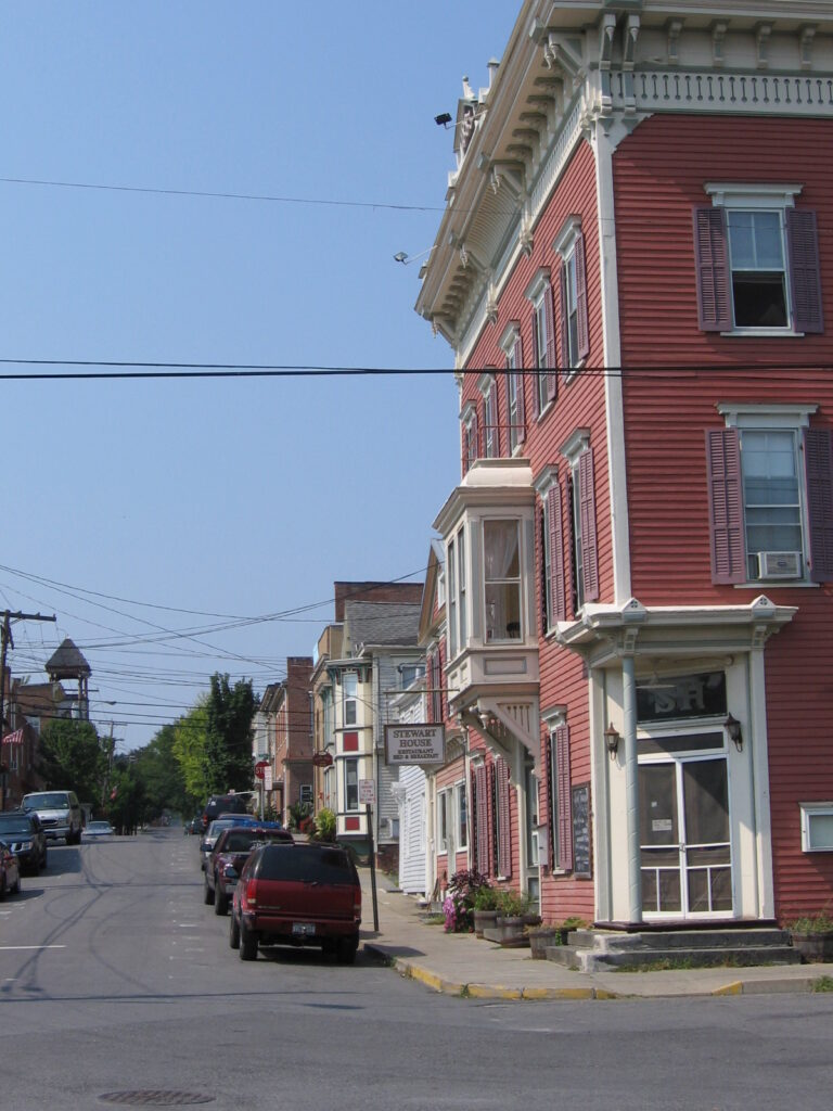 Stewart House and neighboring buildings on a street in Athens village, New York