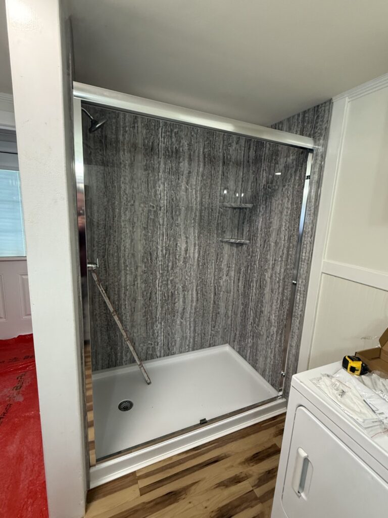 Bath Concepts Quartz smooth acrylic shower with white base, chrome fixtures, two matching corner shelves and glass enclosure in Clifton Park / Halfmoon.