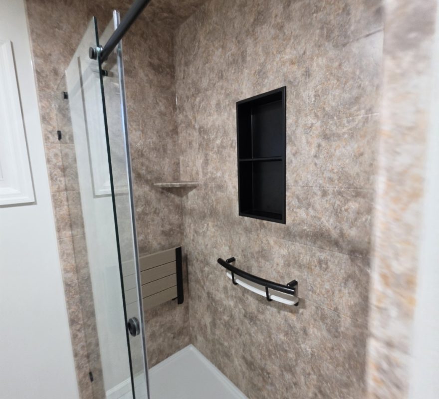 Black HealthCraft INVISIA Shampoo Shelf and grab bar below the niche in a real Moore Done Right Selkirk shower